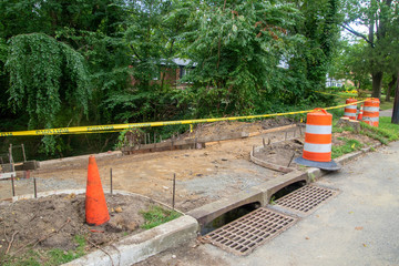 Sidewalk in the process of being replaced. Damaged concrete blocks have been removed and wooden...