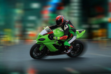 Motorcycle rider racing on the nighttime background