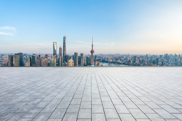 Empty square floor and city skyline with buildings at sunset in Shanghai,China.