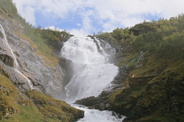 Naklejka na ściany i meble The grand waterfall of Kjosfossen in summer daytime. One of the largest in Norway