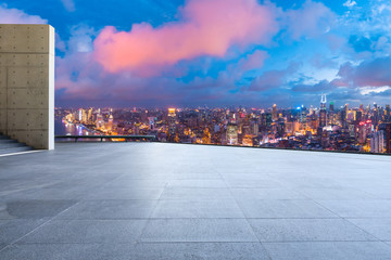 Empty square floor and city skyline with buildings at night in Shanghai,China.