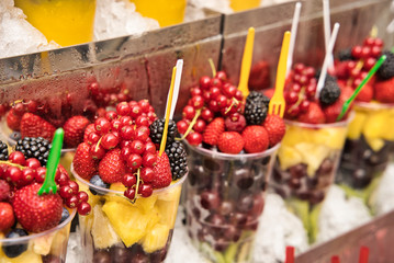 Fototapeta na wymiar Assorted fruit salad in a plastic cup.