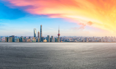 Obraz premium Shanghai skyline and modern buildings with empty race track at sunset,China.