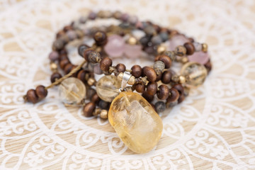 Obraz na płótnie Canvas Citrine mineral stone pendant natural beads necklace on decorative background
