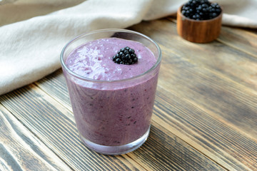 Delicious smoothie with organic blackberries in a transparent glass Healthy eating concept