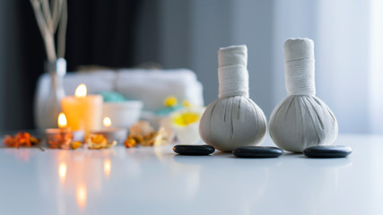 Thai spa massage compress balls and salt spa objects on table background, wellness and relaxation concept