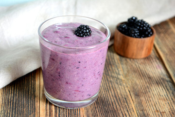 Delicious smoothie with organic blackberries in a transparent glass Healthy eating concept