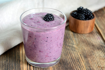 Delicious smoothie with organic blackberries in a transparent glass Healthy eating concept