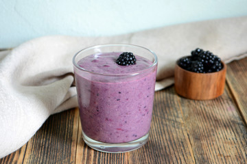 Delicious smoothie with organic blackberries in a transparent glass Healthy eating concept