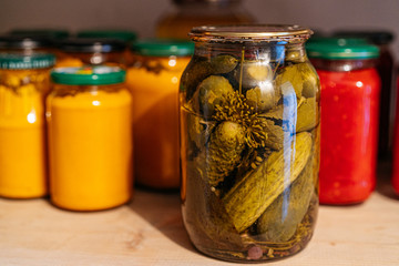 Composition with jars of pickled vegetables. Marinated food.