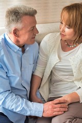 Sweet senior couple sitting in bed