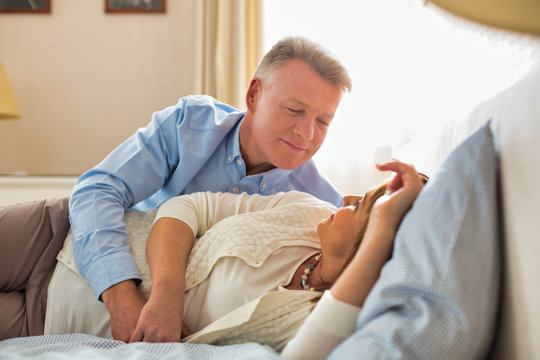 Sweet senior couple cuddling in bed