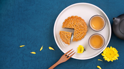 Minimal simplicity layout moon cakes on blue background for Mid-Autumn Festival, creative food design concept, top view, flat lay, copy space.