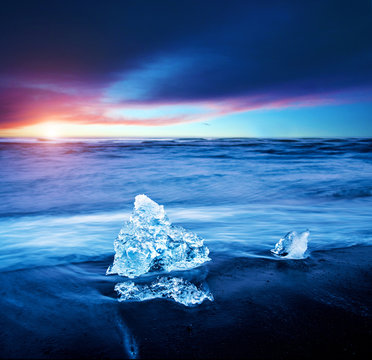 magical charming beautiful landscape with a piece of ice like a sculpture on the Diamond beach near glacier lagoon Jokulsarlon, Iceland. Exotic countries. Amazing places.