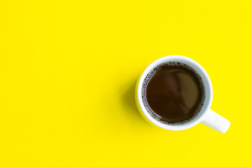 cup of coffee on yellow background. soft focus.