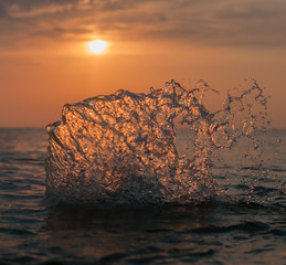 A water splash with a sunset on the background