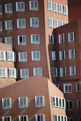 brown interleaved fassade with white windows of the Ghery buildings  