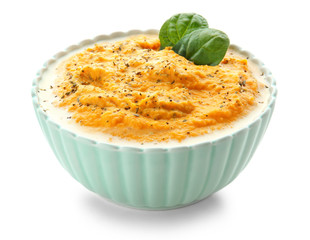 Bowl of tasty cream soup on white background