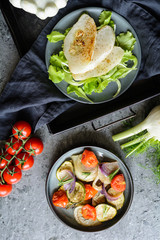 Fried white patty pan squash slices with vegetable garnish