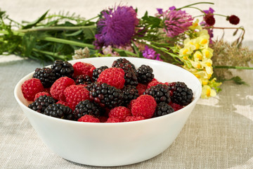 Summer still life with wildflowers and berries.