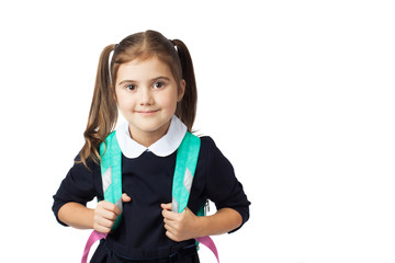 Portrait of a little cute girl with a backpack in the school uniform going to school. Copy space. Isolated on the white background. The concept of education, back to school, etc.
