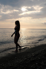 silhouette of woman on the beach at sunset