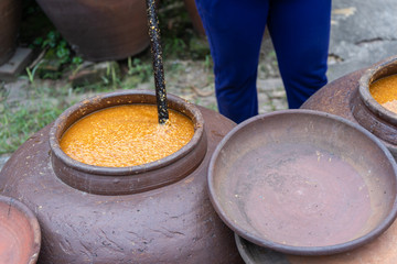 Jars of processing salted soybean paste jam made by traditional outdoor way under natural sunlight production for use ingredient cooking food