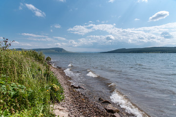 Beautiful summer lanscape, blue sky, mountains, river and grass
