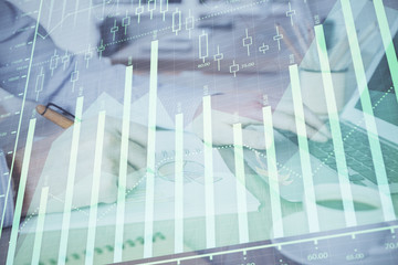 Multi exposure of stock market graph with man working on laptop on background. Concept of financial analysis.