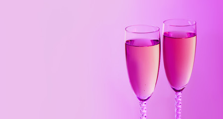 Sparkling New Year on the pink neon background with champagne. Christmas and happy new year 2020 concept. Copy space.