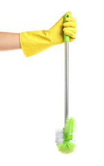 Female hand in glove holding toilet brush on white background
