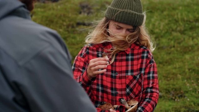 Young woman holds wild mushrooms in hands