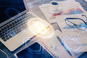 Double exposure of blockchain and crypto economy theme hologram and table with computer background....