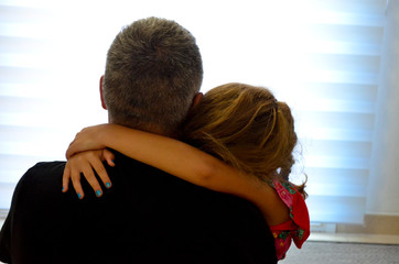 Father and daughter hugging tenderly