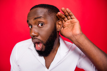 Photo of dark skin guy listen rumours with interest wear white shirt isolated bright red background