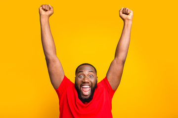 Photo of rejoicing enjoying happy american man screaming with pleasure while isolated with yellow background - obrazy, fototapety, plakaty