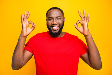 Photo of cheerful rejoicing man having nice deal for you showing you double ok sign friendly...