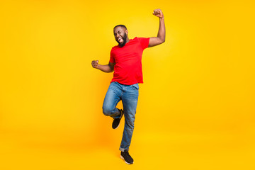 Full length body size photo of rejoicing glad cheerful happy black man dancing with joy while...