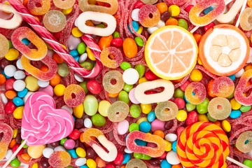Rolgordijnen Colorful lollipops and different colored candies. © Nataliia Pyzhova