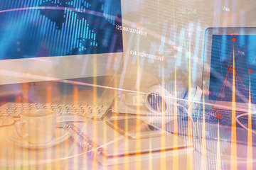 Forex market graph hologram and personal computer on background. Multi exposure. Concept of investment.