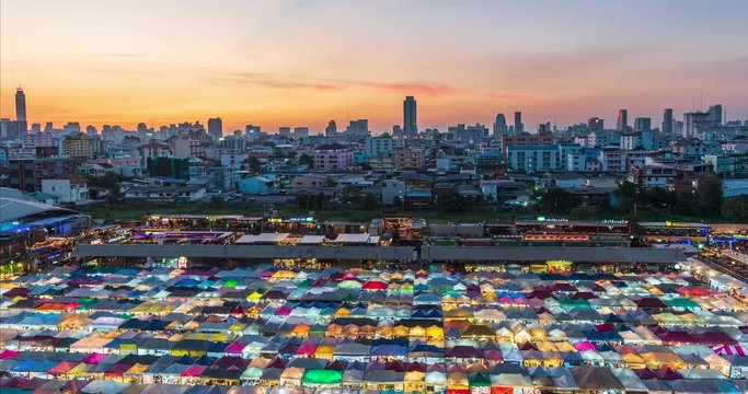 Day to night time lapse of Ratchada Train night market with beautiful sunset in Bangkok,Thailand.
