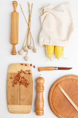 Composition of wooden cutting boards and wooden utensils and kitchen utensils. Top view.