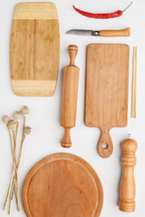 Composition of wooden cutting boards and wooden utensils and kitchen utensils. Top view.