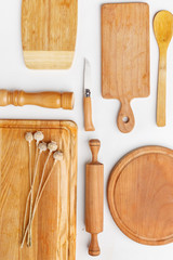Composition of wooden cutting boards and wooden utensils and kitchen utensils. Top view.