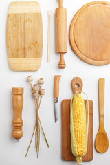 Composition of wooden cutting boards and wooden utensils and kitchen utensils. Top view.