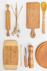 Composition of wooden cutting boards and wooden utensils and kitchen utensils. Top view.