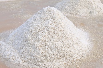 Fototapeta na wymiar Close up shot of a sea salt pile at salt field.