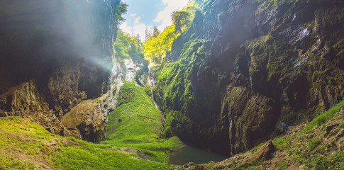 Macocha Gorge - The Macocha Abyss (Propast Macocha). Sinkhole in the Moravian Karst Punkva caves system of the Czech Republic. View from the bottom of the abyss. - obrazy, fototapety, plakaty