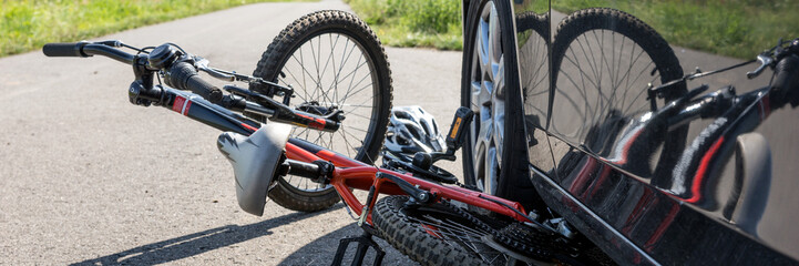 Children's bicycle accident with car on the street. Panoramic image