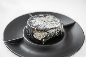 Thurgau is a fine hard Swiss cheese with the aroma of onion bread. Cheese is made in the Canton of Thurgau on lake Constance. The head of cheese is decorated with pepper on a white plate.